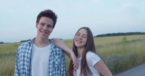 Portrait of Happy Young Girl Leans on Male Shoulder and They Smiling at Camera