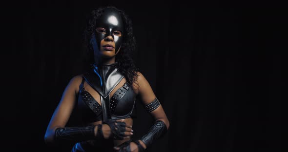Beautiful Young Black Woman in Leather Outfit and Catwoman Mask Posing