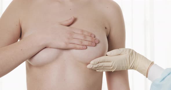 Doctor Checking Woman's Breast at Hospital. Breast Cancer Prevention. Close Up.