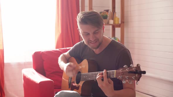 Man Plays Guitar and Sings