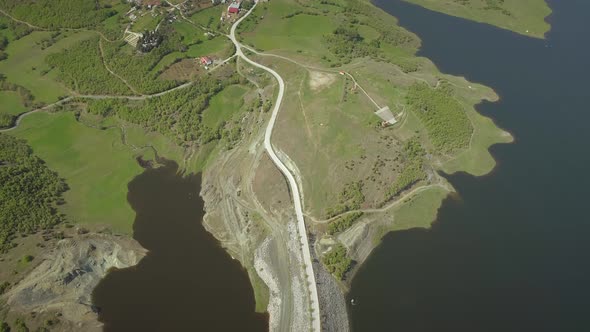 Aerial view of highway road in Techniti Limni Smokovou lake in Greece.