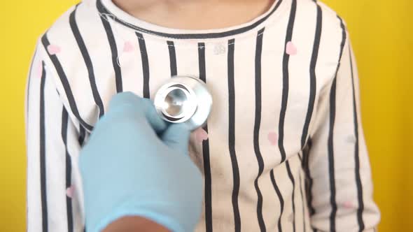 Doctor Using a Stethoscope Checking Child Body Close Up