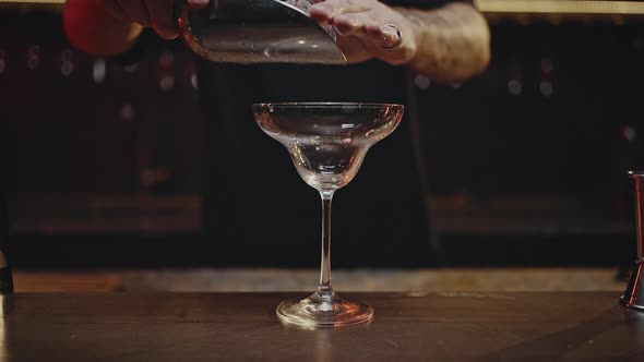 Bartender Fills Glass with Professional Crystal Ice Cubes