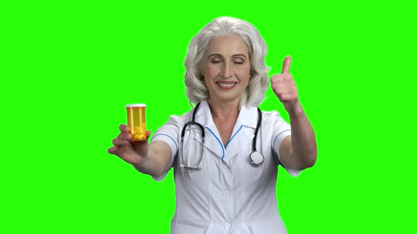 Female Doctor Showing Pills and Thumb Up