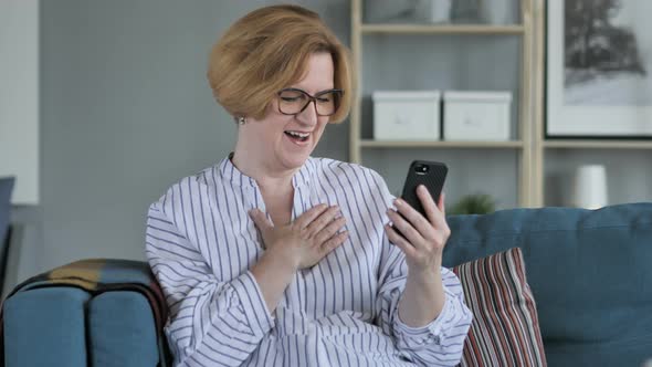 Old Woman Excited for Success while Using Smartphone