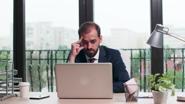 Concentrated Corporate Worker in Business Suit Reads an Email