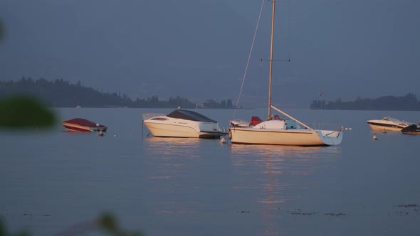 First darkness on the ravishing beautiful Lake Garda with different boats in the foreground