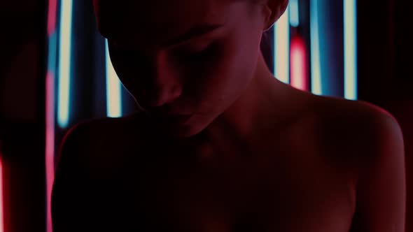 Sensual Woman Under Neon Illumination