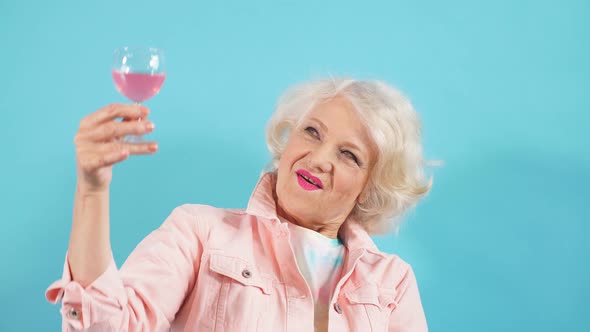 Happy Positive Grandma with Glass Looking at the Camera, Celebrating Her Birthday. Happiness