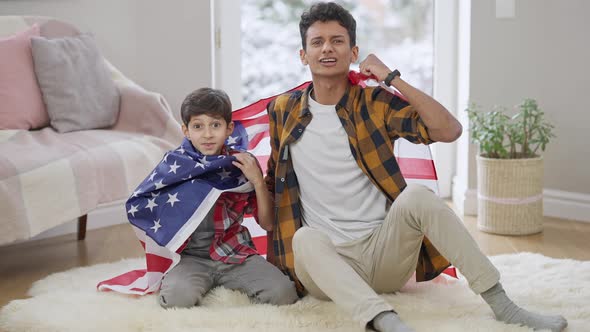 Wide Shot of Excited Sport Fans Watching Match at Home with American Flag and Rejoicing Victory