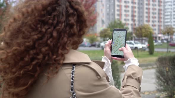 Woman Outdoors Holding Smartphone with City Map