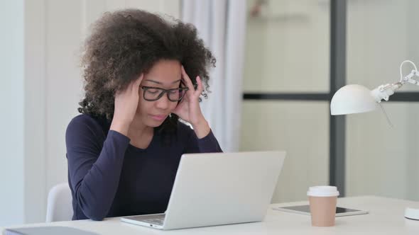 African Woman Having Headache While Using Laptop