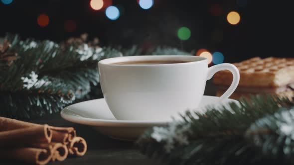 White cup of hot coffee on a brown wooden table