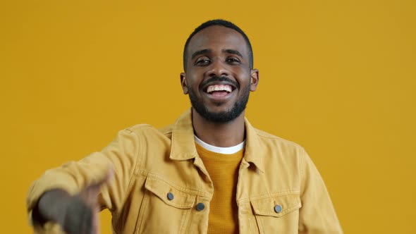 Portrait of Romantic African American Man Sending Air Kisses and Looking at Camera