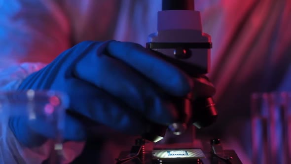 researcher in scientific laboratory examines ultra modern processor microscope.