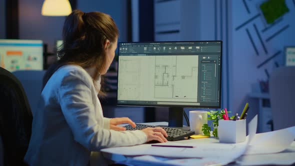 Woman Architect Matching Digital Plans From Pc with Blueprints