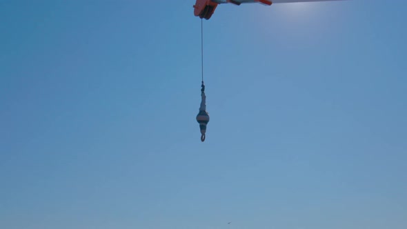 Crane at Barrons Boatyard at City Island in New York on a sunny day with Hart island in the backgrou