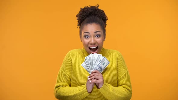 Excited African-American Woman Holding Bunch of Dollars, Lottery Winner, Fortune