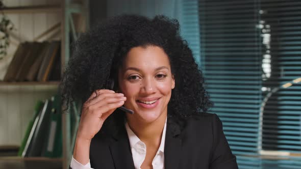 Portrait of African American Woman in Business Suit Talking on Headphones Call Center