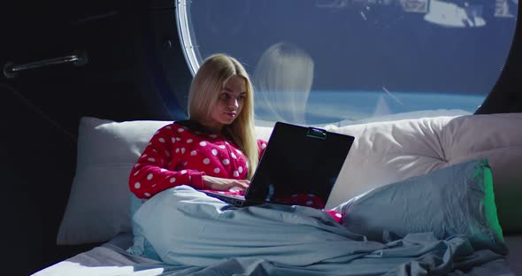 Woman Using Laptop in a Spaceship