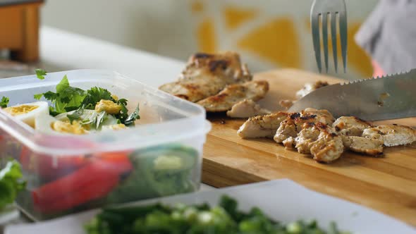 Woman Preparing Healthy Vegetable Chicken Salad in the Home Kitchen.