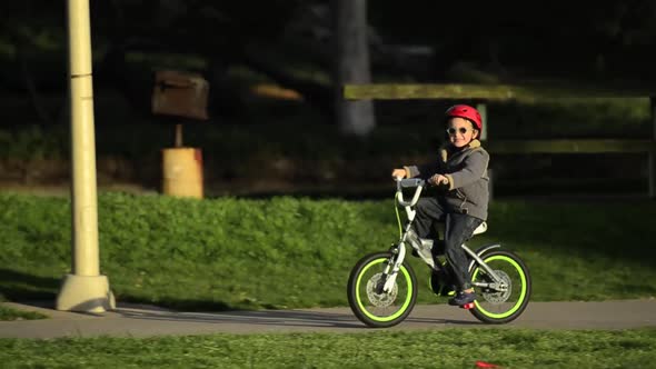 A boy riding a bike in a park.