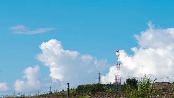 Movement of Cumulus Clouds Behind a Hill with a TV Tower on Top