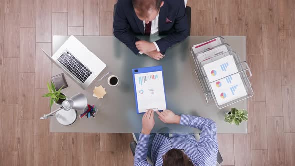 Top View of Businessman in Suit Shaking Hands with Manager