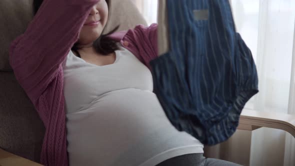 Happy Pregnant Woman and Expecting Baby at Home