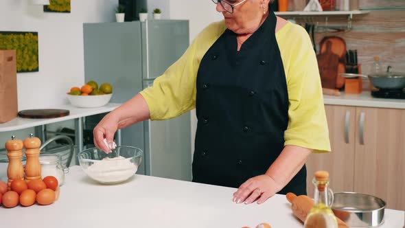 Taking Flour From Glass Bowl