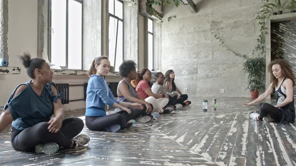 Young Women Stretching in Flexibility Class