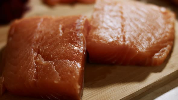 Macro View of Fresh Salmon Fillet on a Wooden Board Ready to Be Prepared