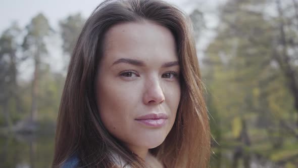 Close Up Portrait of Pretty Young Glamour Smiling Woman Looking in the Camera. Beautiful Landscape