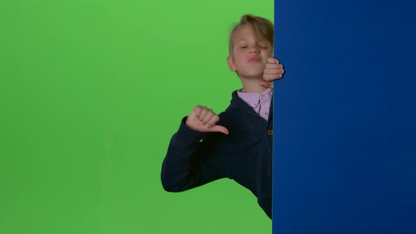 Child Boy Appears From the Side of the Board and Shows Dislike and Then Like on a Green Screen