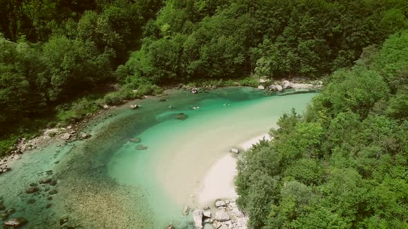 Aerial view of a group doing water rafting on the rapids at Soca River.