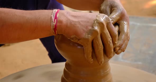 Skilled Hands of Potter Shaping the Clay on Potter Wheel and Sculpting Clay Pot Jar. Udaipur