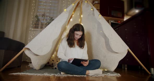 Woman Sit on the Floor and Use Tablet