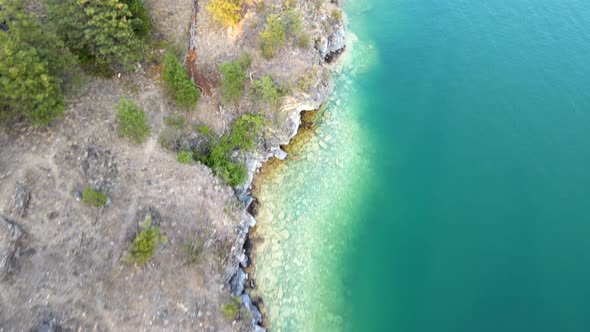 Aerial vertical view flying over beautiful turquoise water of kalamalka lake in British Columbia Can