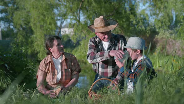 Happy Joyful Family Elderly Woman with Her Husband and Little Cheerful Cute Grandson Enjoy Picnic in