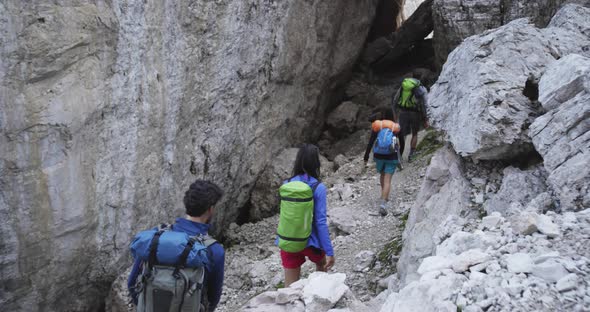 Four Friends Walking Along Hiking Trail Rocky Canyon Path