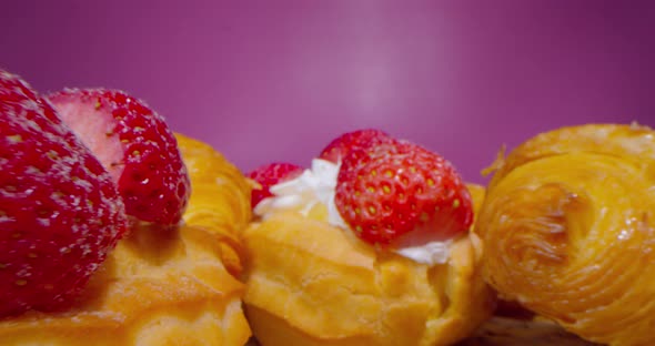 Macro Shot of Donuts with Cream and Strawberry Slices on a Dark Rosy Background Macro Lens Passing