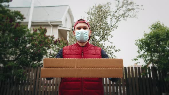 Delivery Man Holding Cardboard Boxes in Medical Gloves and Mask Coronavirus Pandemic Quarantine Home