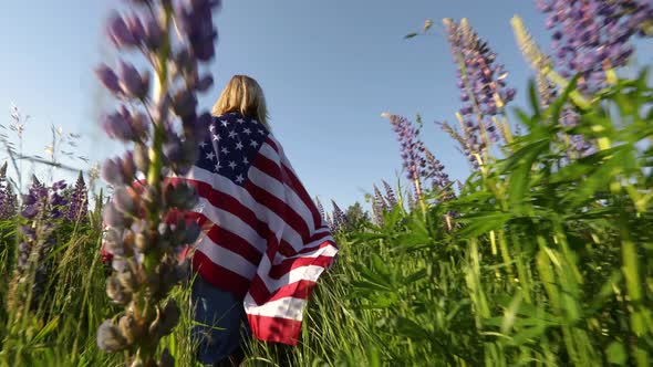 Woman With American Flag  In Meadow Low Angle View