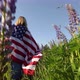 Woman With American Flag  In Meadow Low Angle View - VideoHive Item for Sale