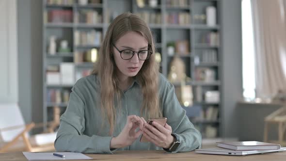 Shocked Young Woman Getting Upset While Using Smartphone