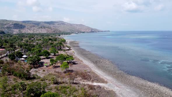 Aerial drone lowering over the small idyllic, rugged and remote snorkeling, diving paradise destinat