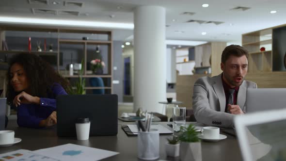 Diverse Coworkers Group Talk Discuss Corporate Project in Business Centre Office