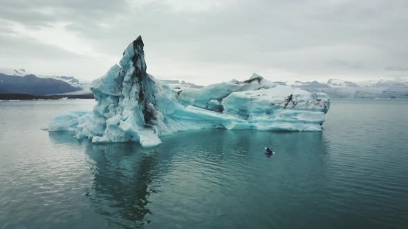 an aerial of a kayaker in jokulsarlon glacier lagoon