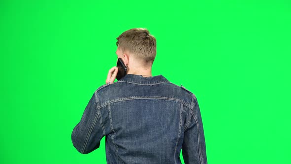 Back View of Guy Goes and Talks on the Phone. Chroma Key