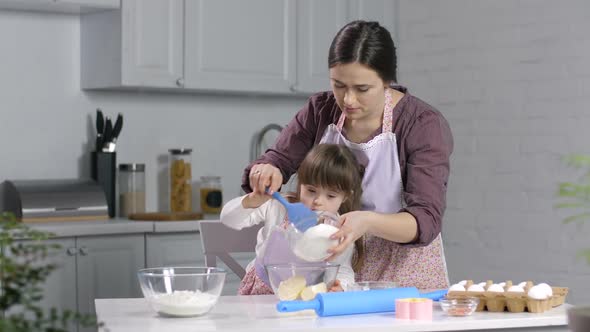 Child with Special Needs Baking with Mother